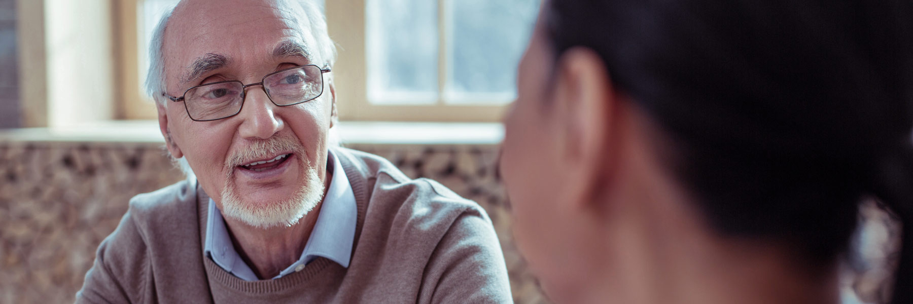 Elderly man speaking with a service provider.