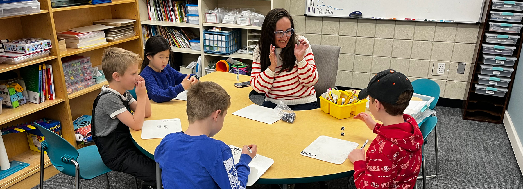 Teacher and students in a classroom.