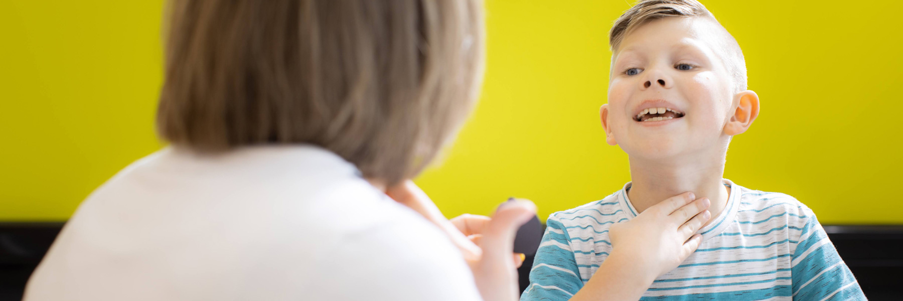 Kid practising exercises with speech-language pathologist