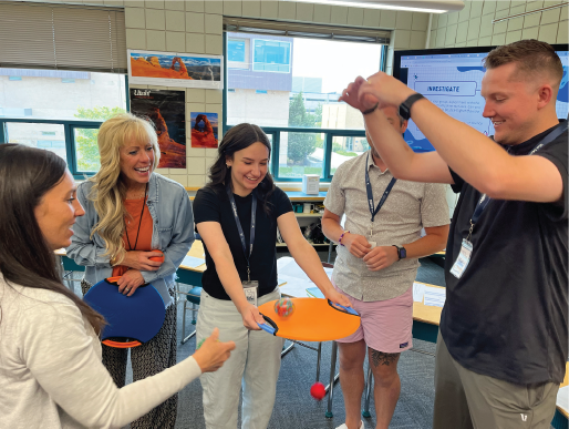 A group of teachers playing an interactive math game.