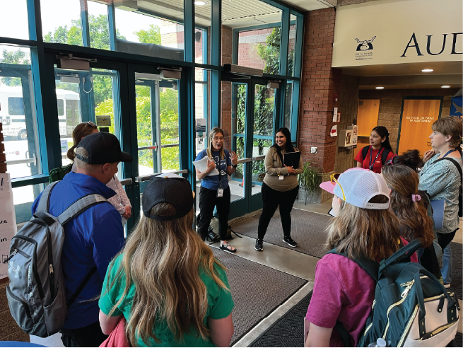 A group of teachers circled up to watch a presentation.