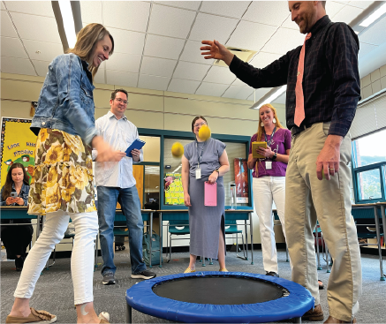 A group of teachers playing an interactive math game.