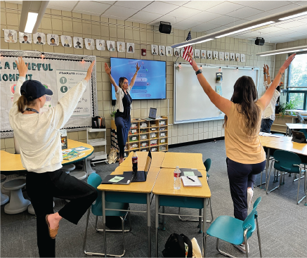 Teachers participate in a yoga-based wellness activity.