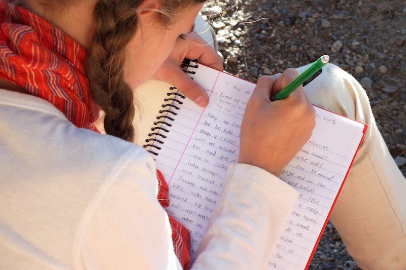 Student Writing in Notebook