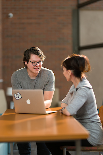 A man talking to a woman.