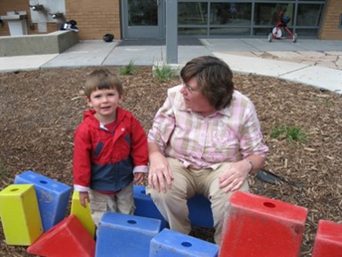 Woman and toddler playing with blocks