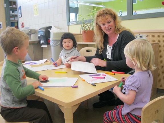 Woman and three children around a table