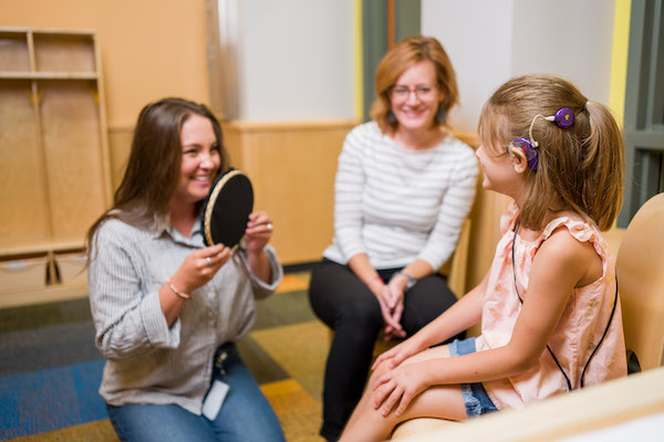 A graduate student in the LSL graduate training program works with a student in the Sound Beginnings program for the deaf and hard of hearing.