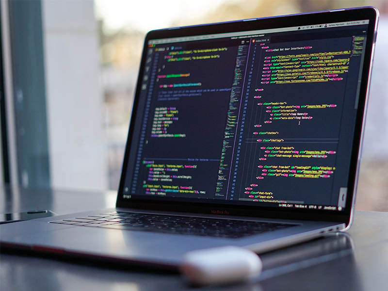 laptop with code displaying on screen