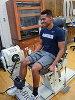 student on machine in a lab