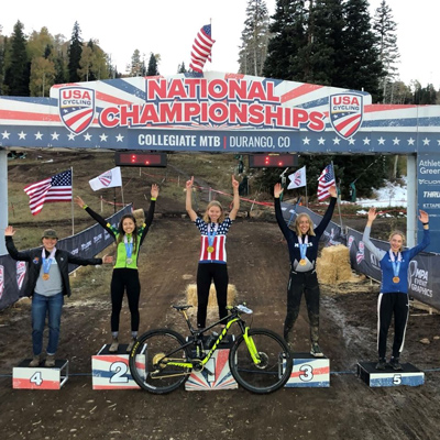 Gwendolyn Sepp posing with other winners at the finish line