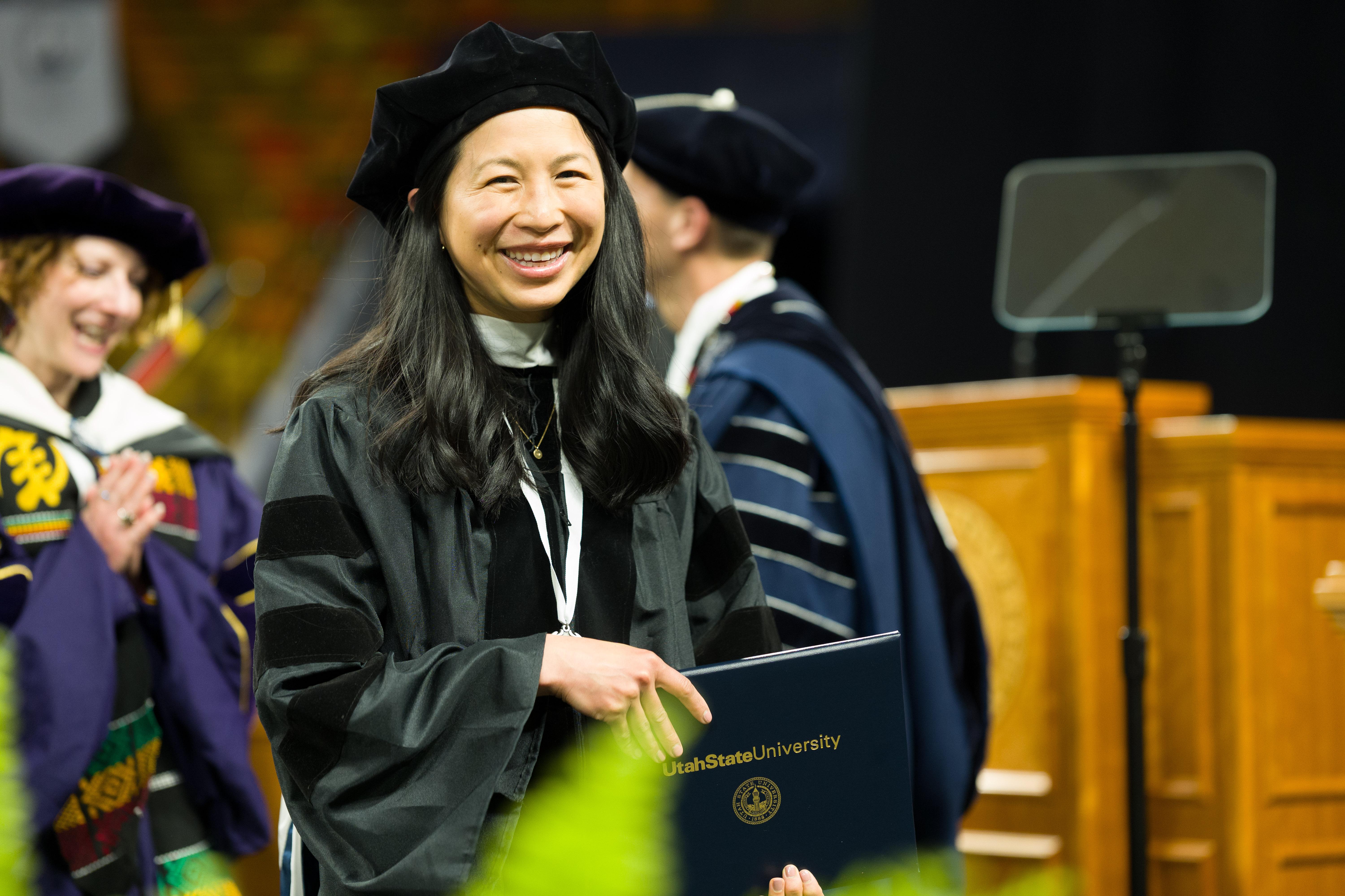 a graduate accepting their diploma