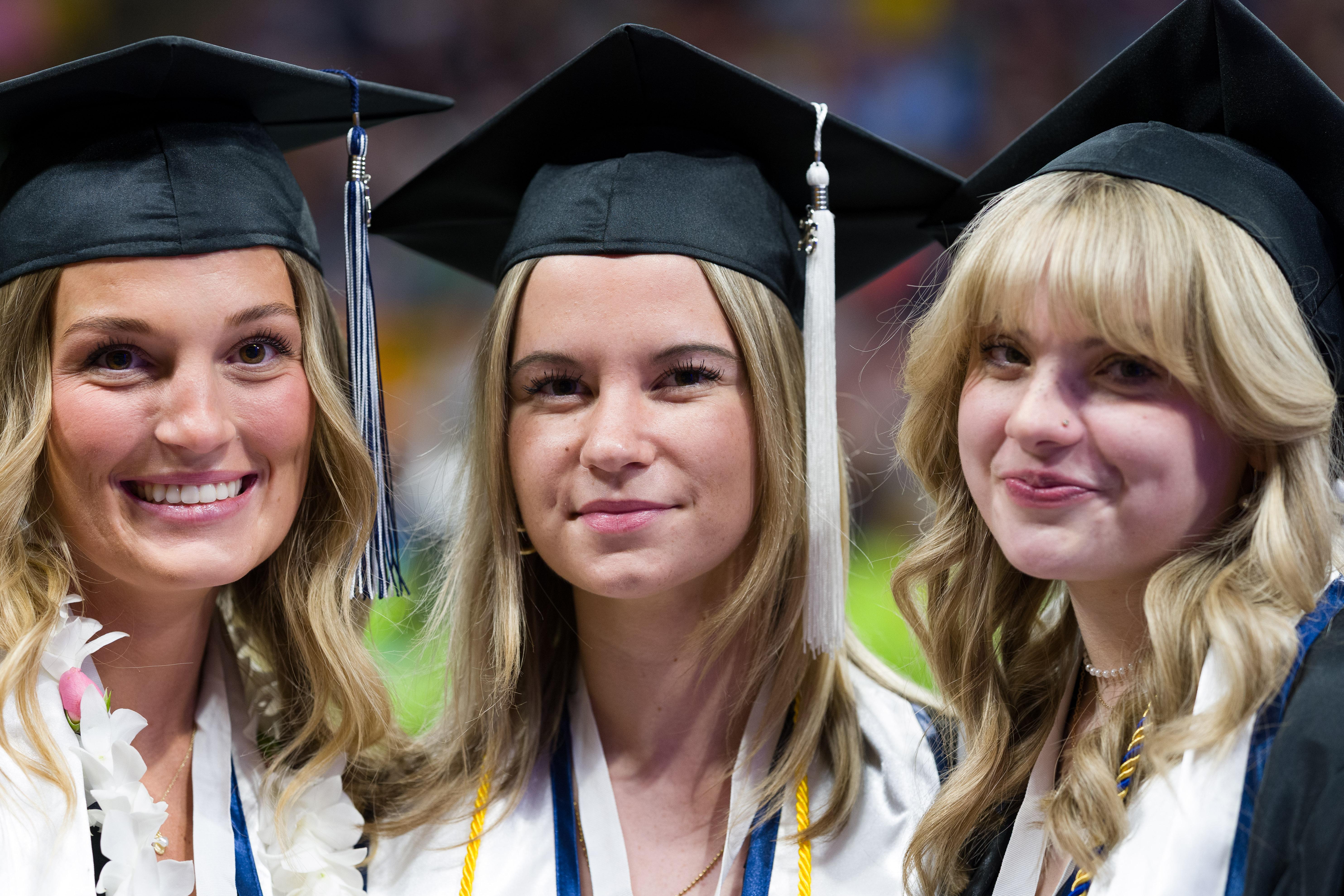 graduates posing for the camera