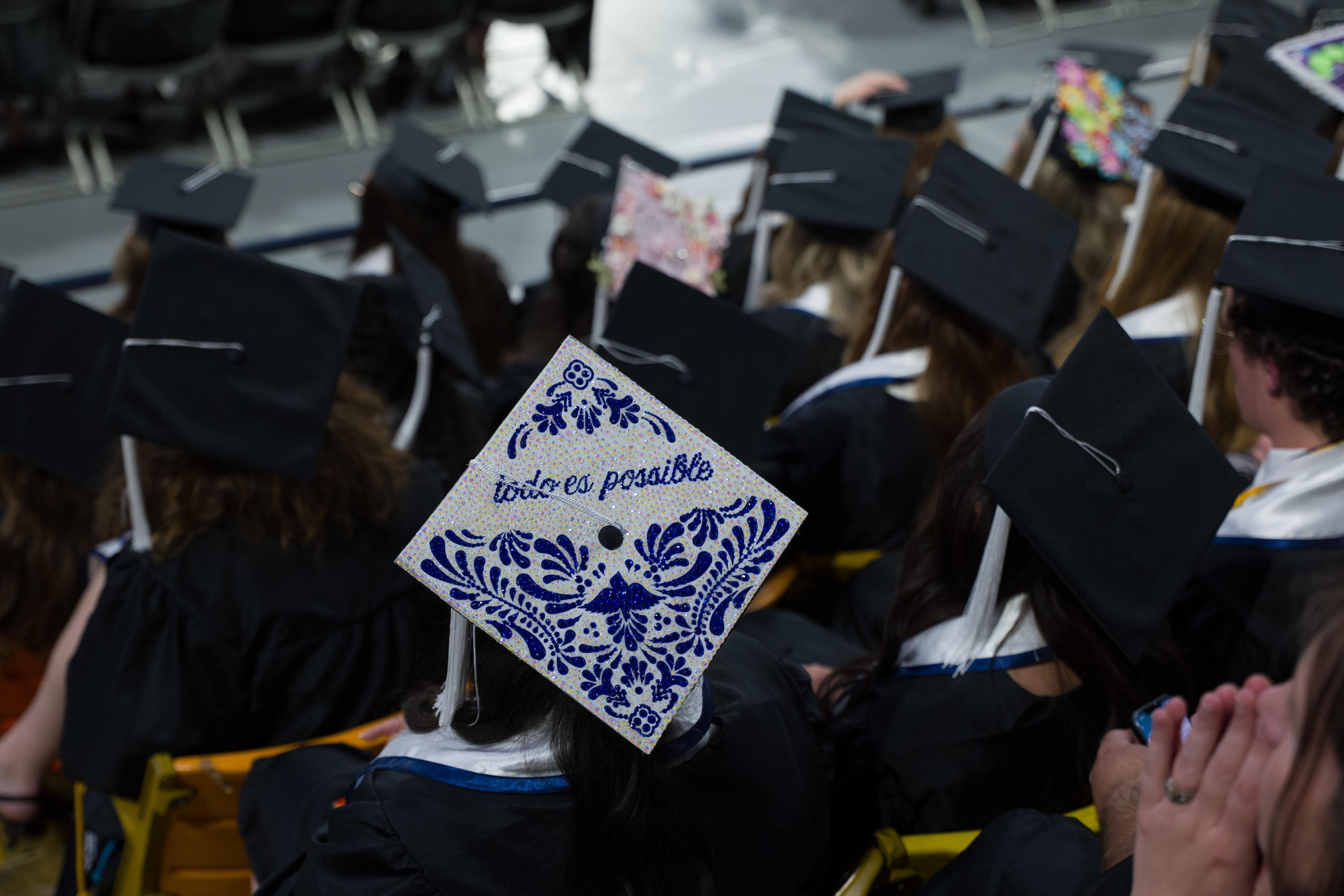 an audience of graduates with there hats from behind