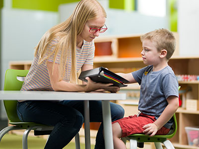 Instructor doing reading exercises with a kid.