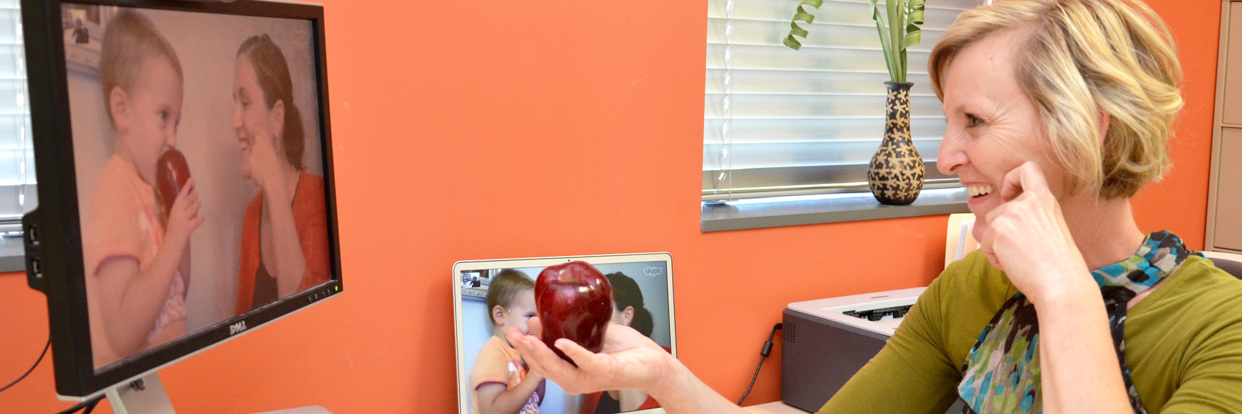 Instructor conducting online session with parent and kid.