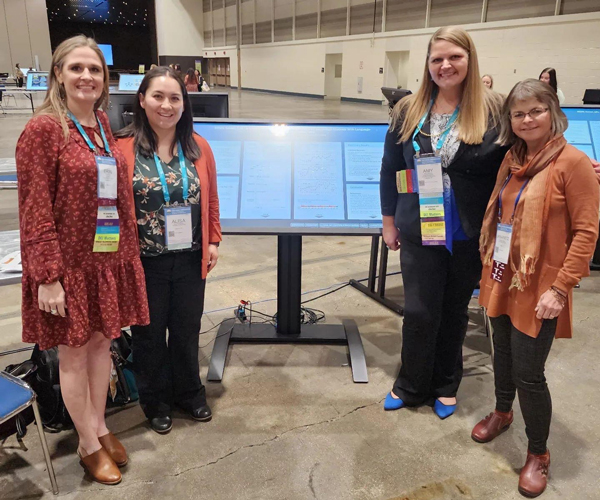 Students presenting a poster at conference