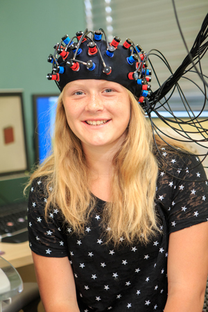 Girl with experiment equipment smiling at the camera