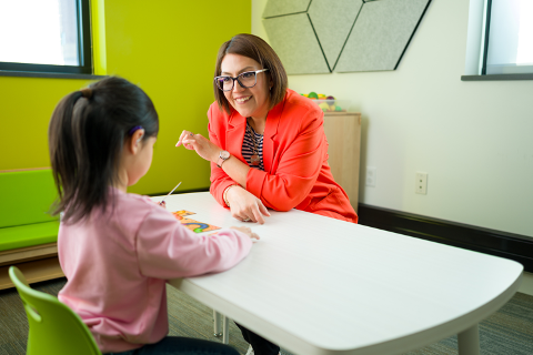 Kid and Instructor in a classroom.