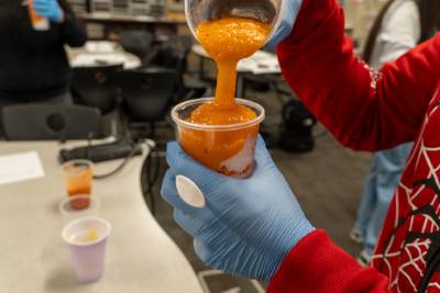 Student pouring their raspado design