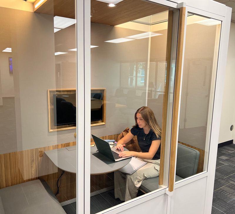 Student meeting space designed for Zoom calls or small group meetings. Student working inside a pod in YETC.